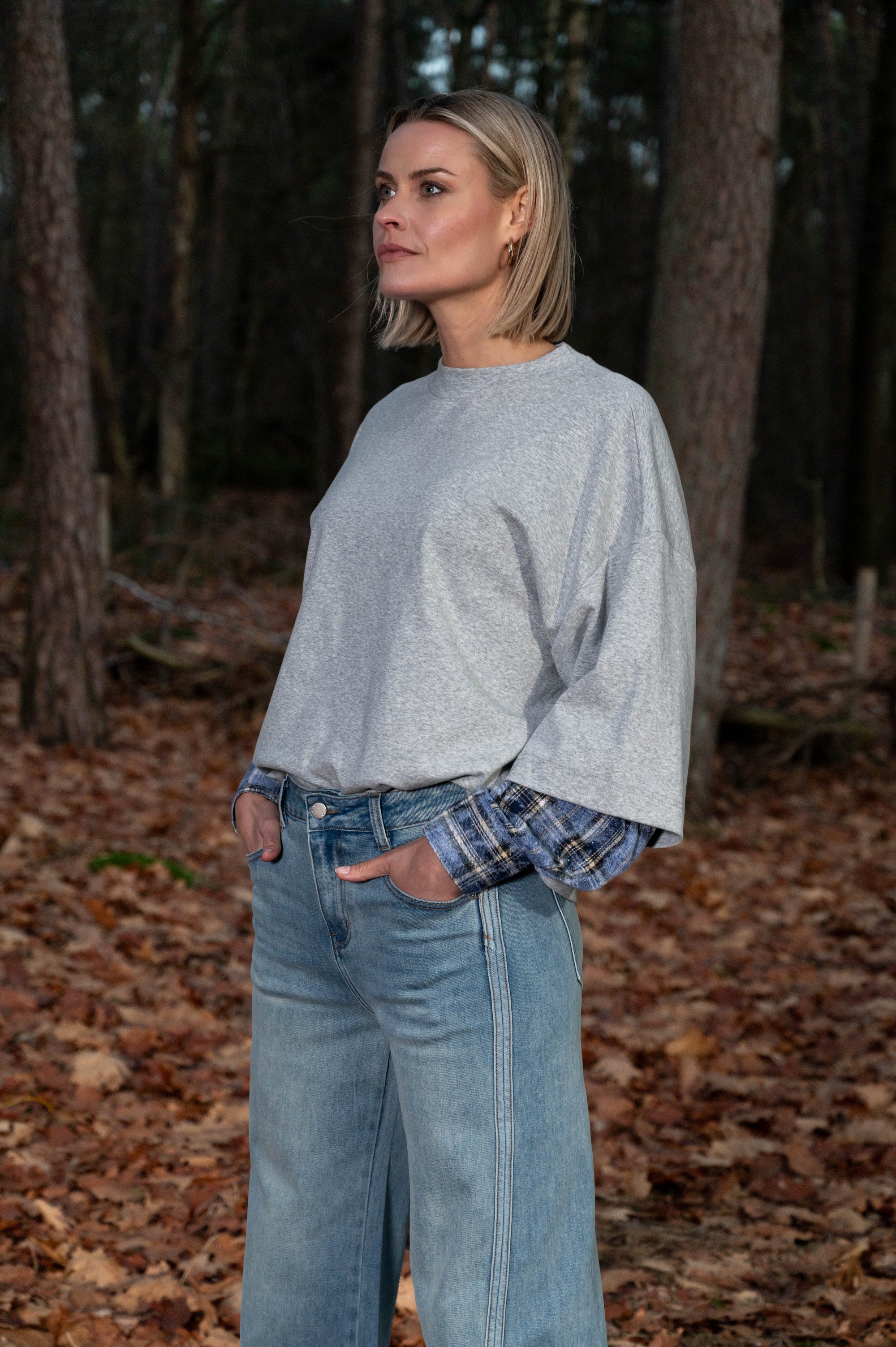 model draagt een oversized shirt op een blauwe jeans 
