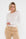offwhite shirt met lange mouwen op een beige broek met dubbele knoopsluiting